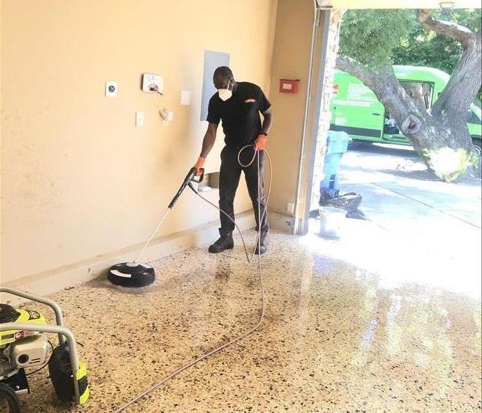 A Man holding a pressure washer