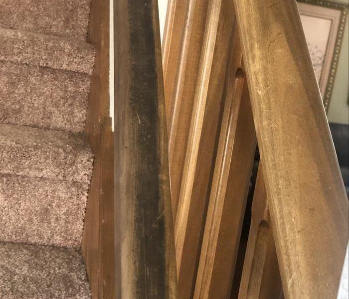 Soot stained stair railing 