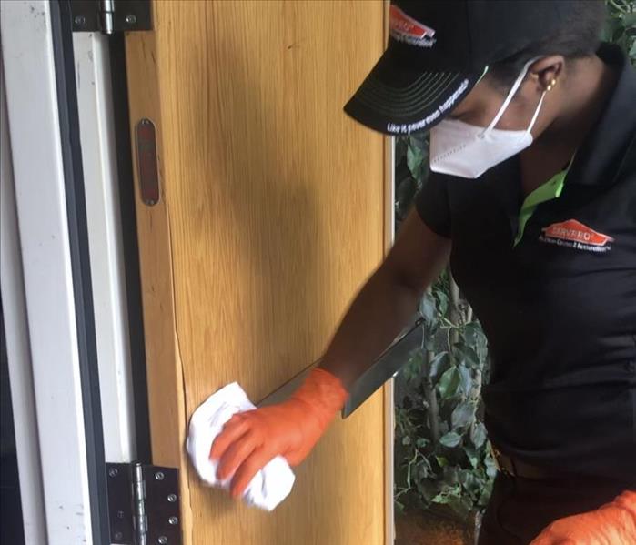 A lady on our team cleaning the high touch areas in a sanctuary