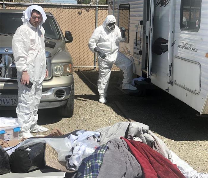 Crew taking a break from disinfecting a trailer home