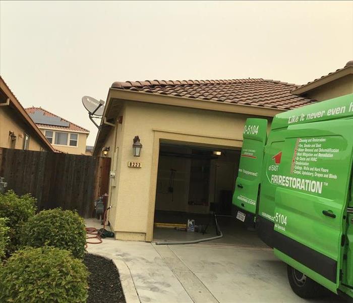 Green SERVPRO van parked outside of a home.