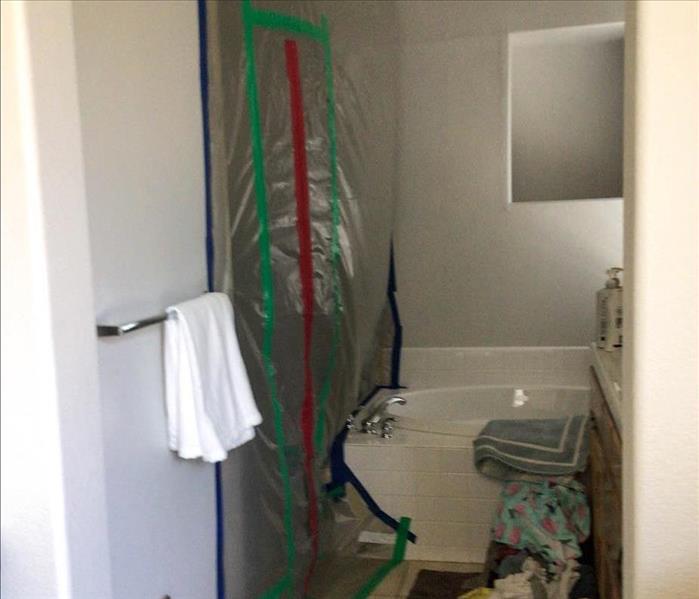 Mold remediation containment setup in a bathroom.